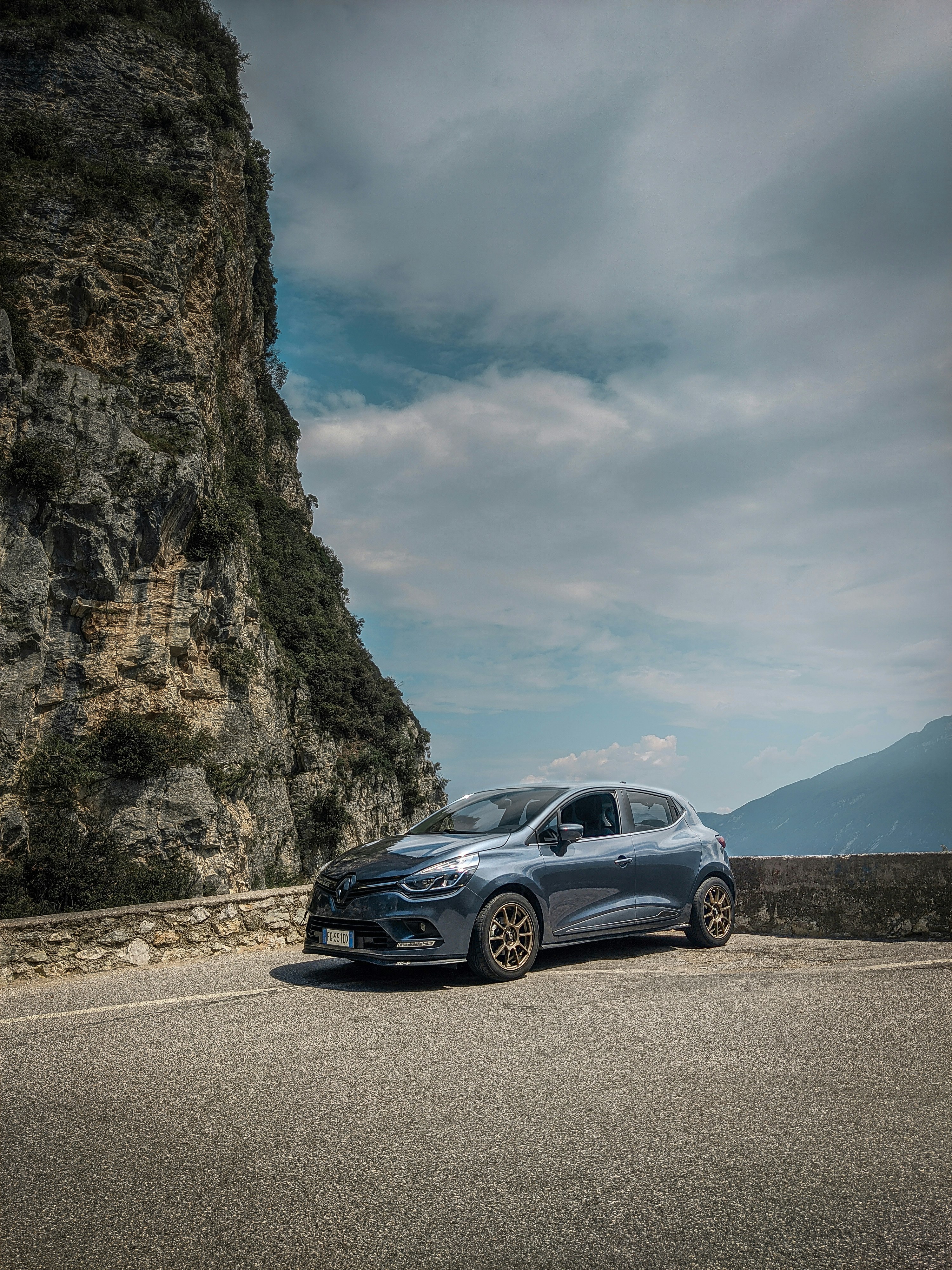 gray mercedes benz coupe on road near mountain during daytime